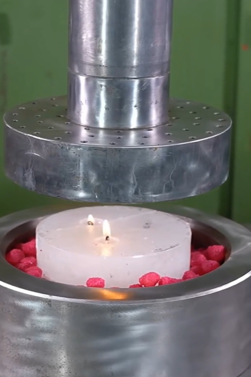 Candle With Raspberries Under Hydraulic Press