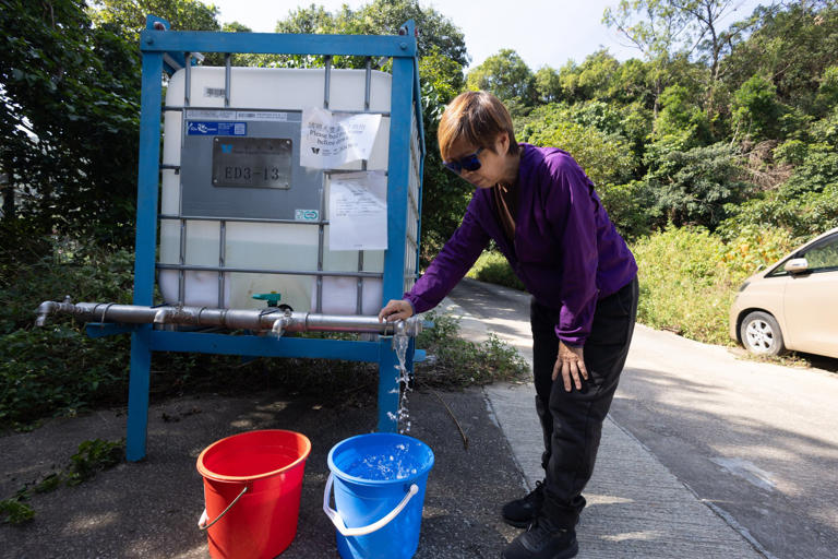 Yip says her arms are sore from carrying water buckets to her home every day. Photo: Dickson Lee
