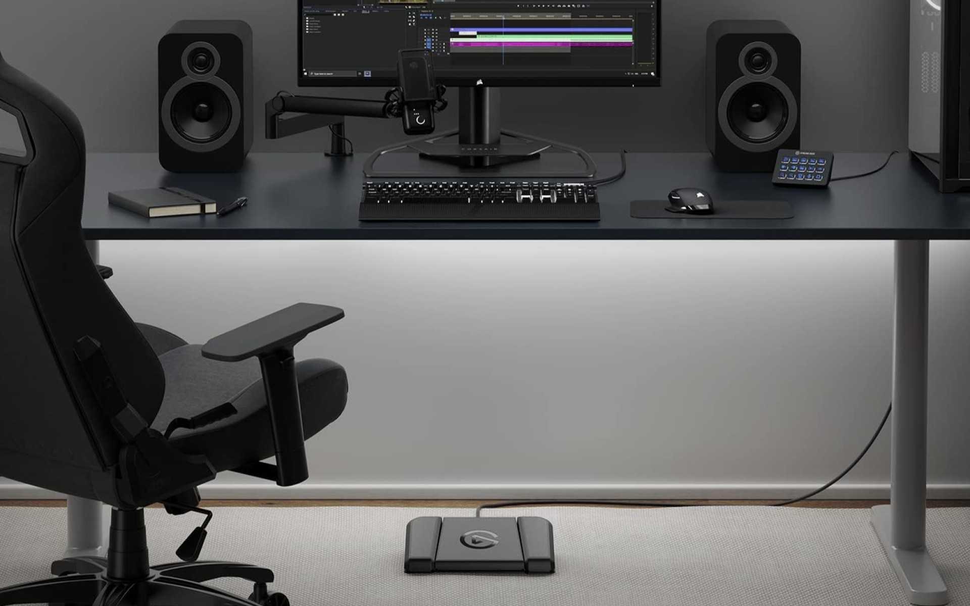 An Elgato Stream Deck USB Pedal placed underneath a computer desk.