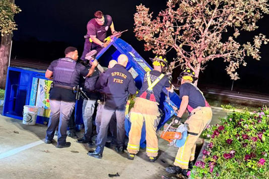 Rescuers trying to free the trapped man