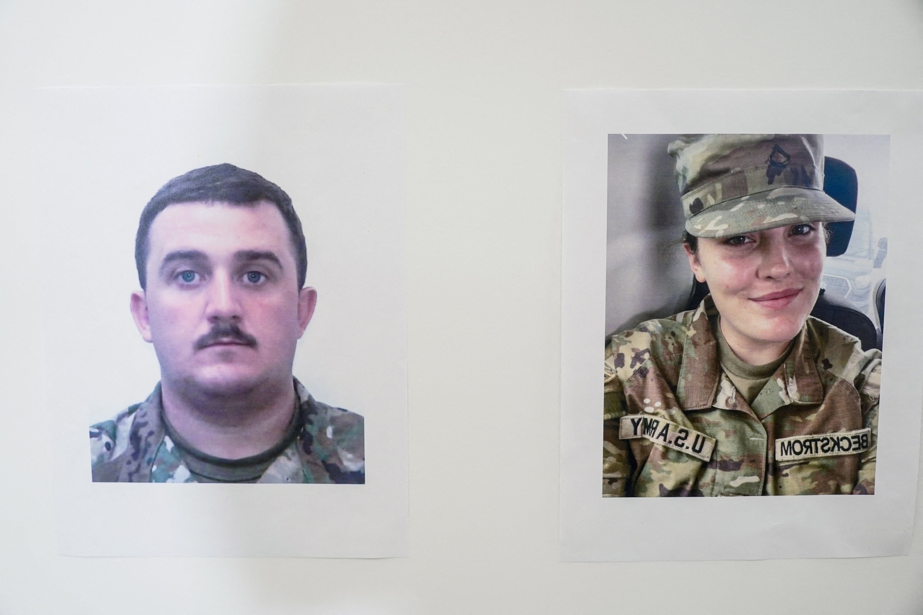 Nathan Howard/Reuters - PHOTO: Pictures of National Guard members Andrew Wolfe and Sarah Beckstrom are displayed at a press conference, after they were shot in Washington, D.C., Nov. 27, 2025.