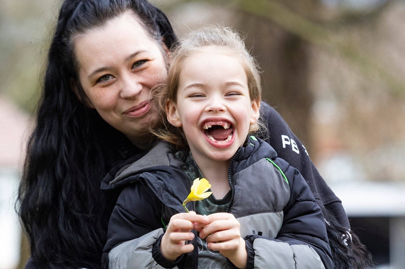 Lisa with her daughter smiling in park