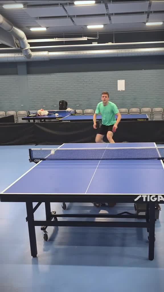 Intense Table Tennis Rally: Who Will Win This Fast-Paced Match?