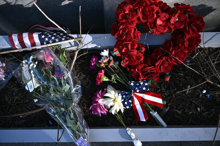 Brendan Smialowski/AFP via Getty Images - PHOTO: A makeshift memorial has been set up in honor of the two National Guard service members shot near the Farragut West Metro Station in Washington, D.C., on Nov. 28, 2025.