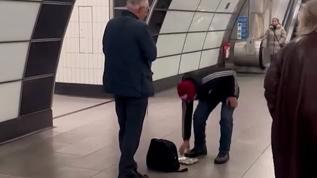 Moment brazen thief steals money from busker on London underground
