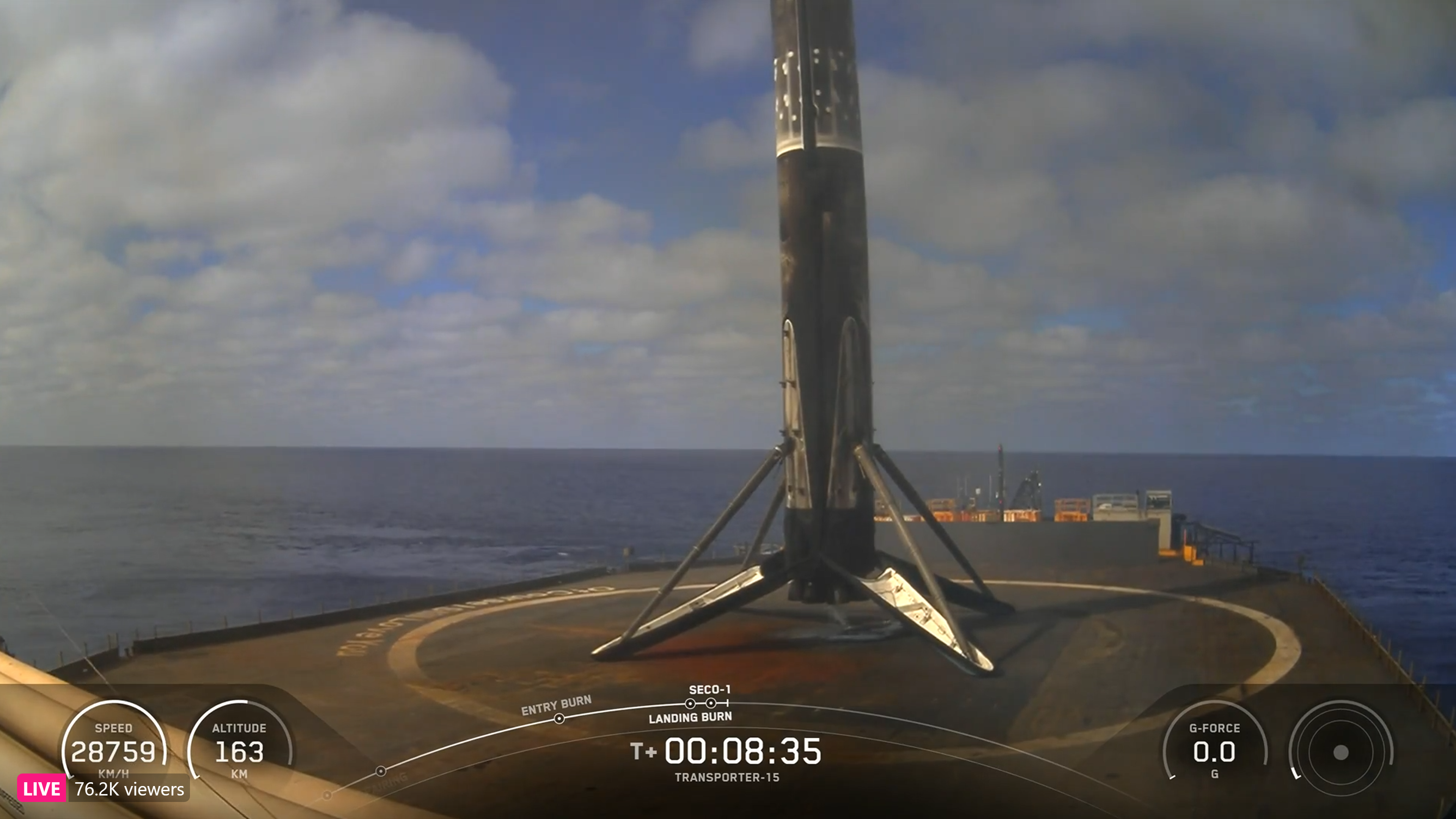 A used SpaceX rocket on an ocean landing pad after touchdown.
