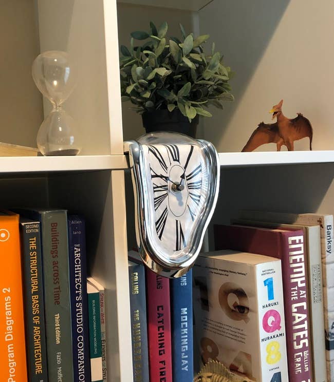 clock on reviewer's book shelf hanging off