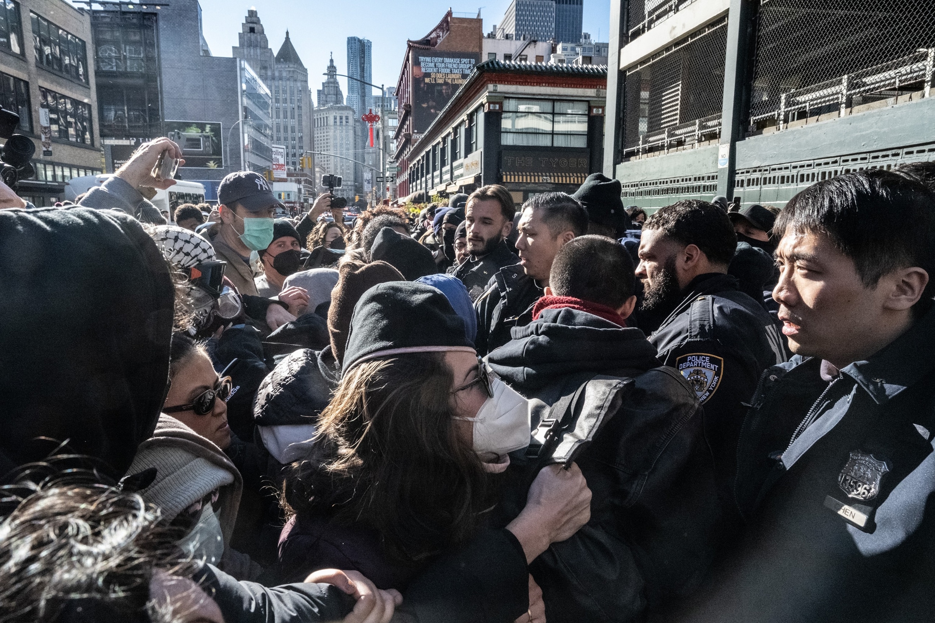 Stephanie Keith/Getty Images - PHOTO: Immigration activists block a garage used by ICE vans during a protest against a purported ICE raid on Canal Street, on Nov. 29, 2025, in New York.