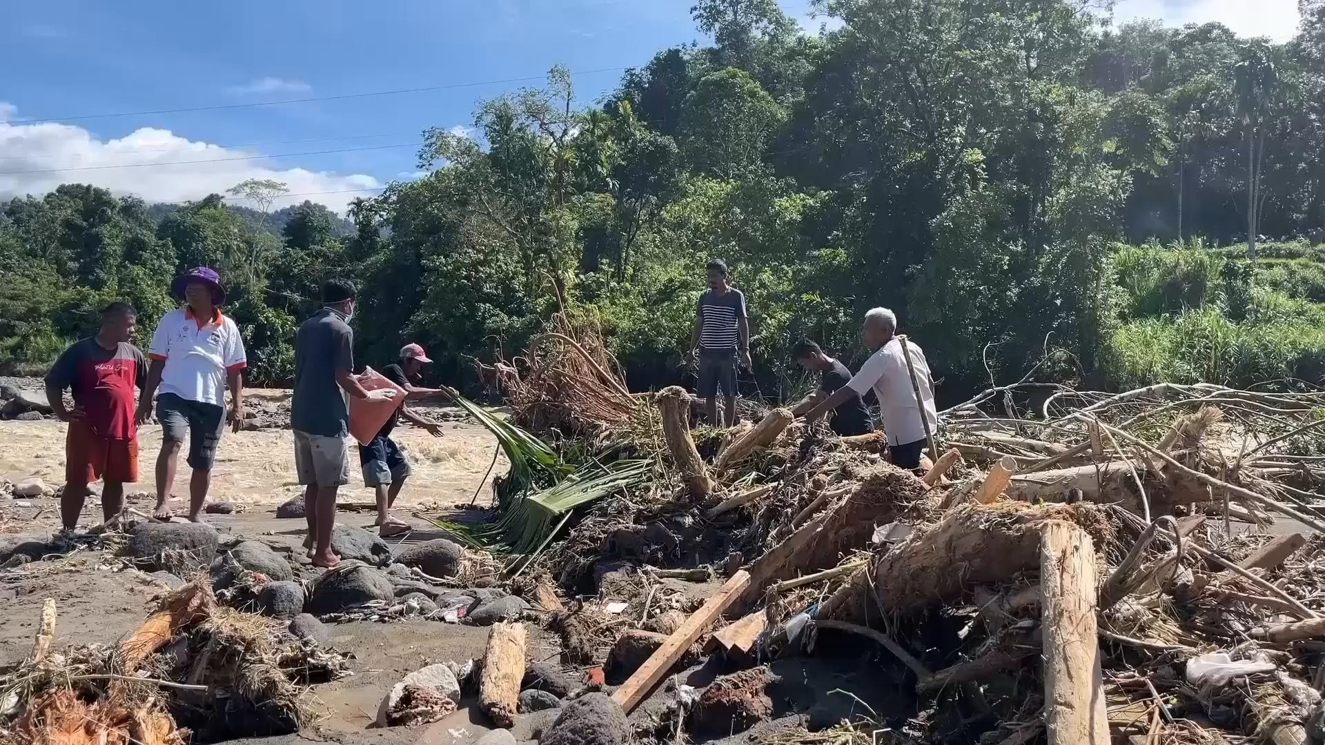 Search for survivors in Indonesia as the death toll from floods and ...
