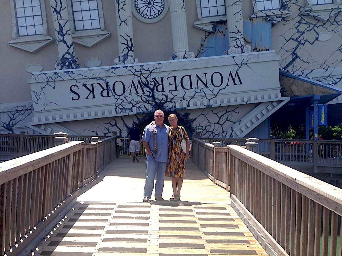 Morgan and wife standing in front of WonderWorks entrance.