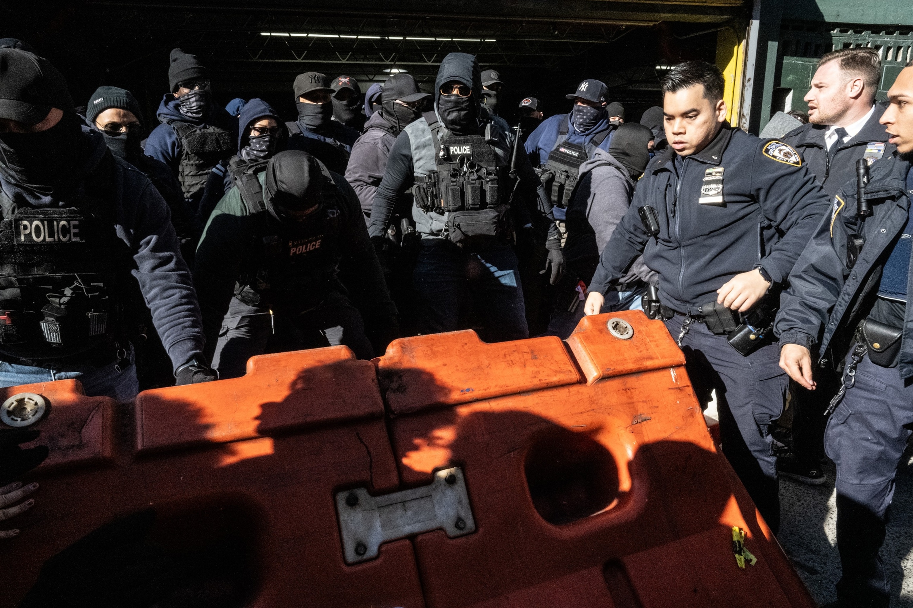 Stephanie Keith/Getty Images - PHOTO: NYPD responds as immigration activists block a garage used by ICE vans during a protest against a purported ICE raid on Canal Street, on Nov. 29, 2025, in New York.