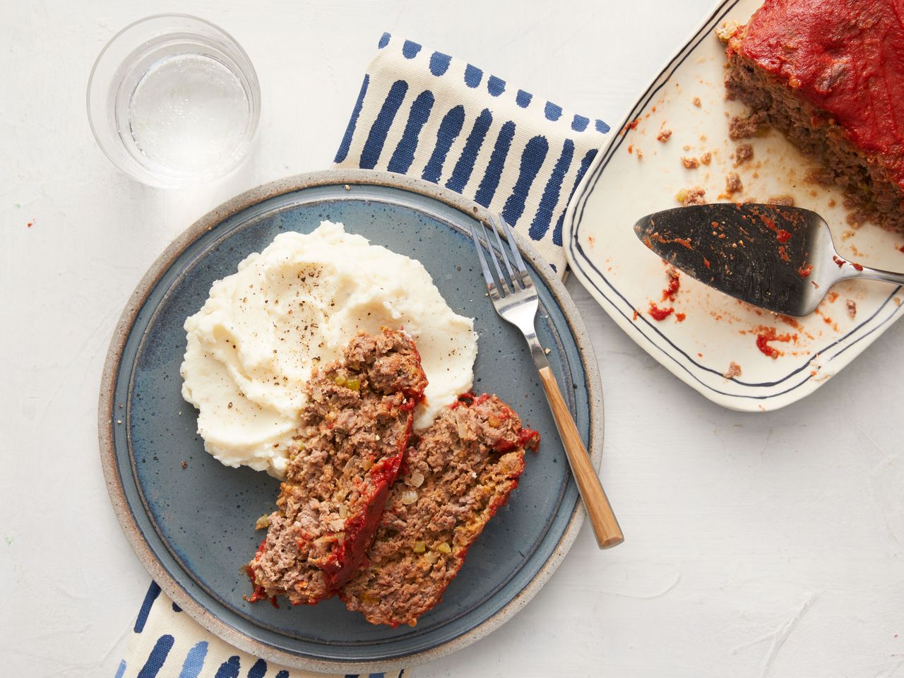 Southern Living Old Fashioned Meatloaf on a plate to serve with mashed potatoes