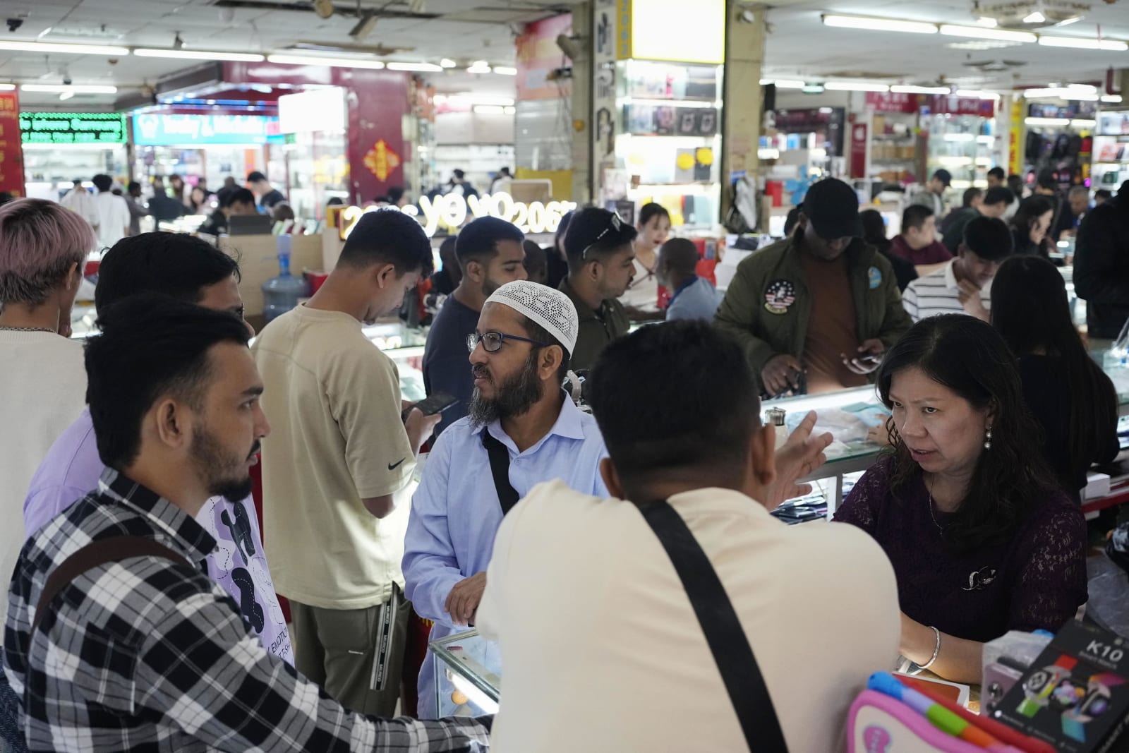 People negotiate purchases in a building that sells second-hand products in Guangzhou, China, on Oct. 24, 2025. (Kyodo)
