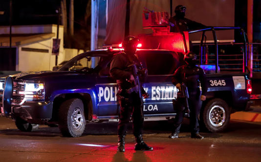 Sinaloa state police agents stand guard during a security operation in the city of Culiacan, Sinaloa state, Mexico on 15 February 2019. Photograph: Rashide Frias/AFP/Getty Images