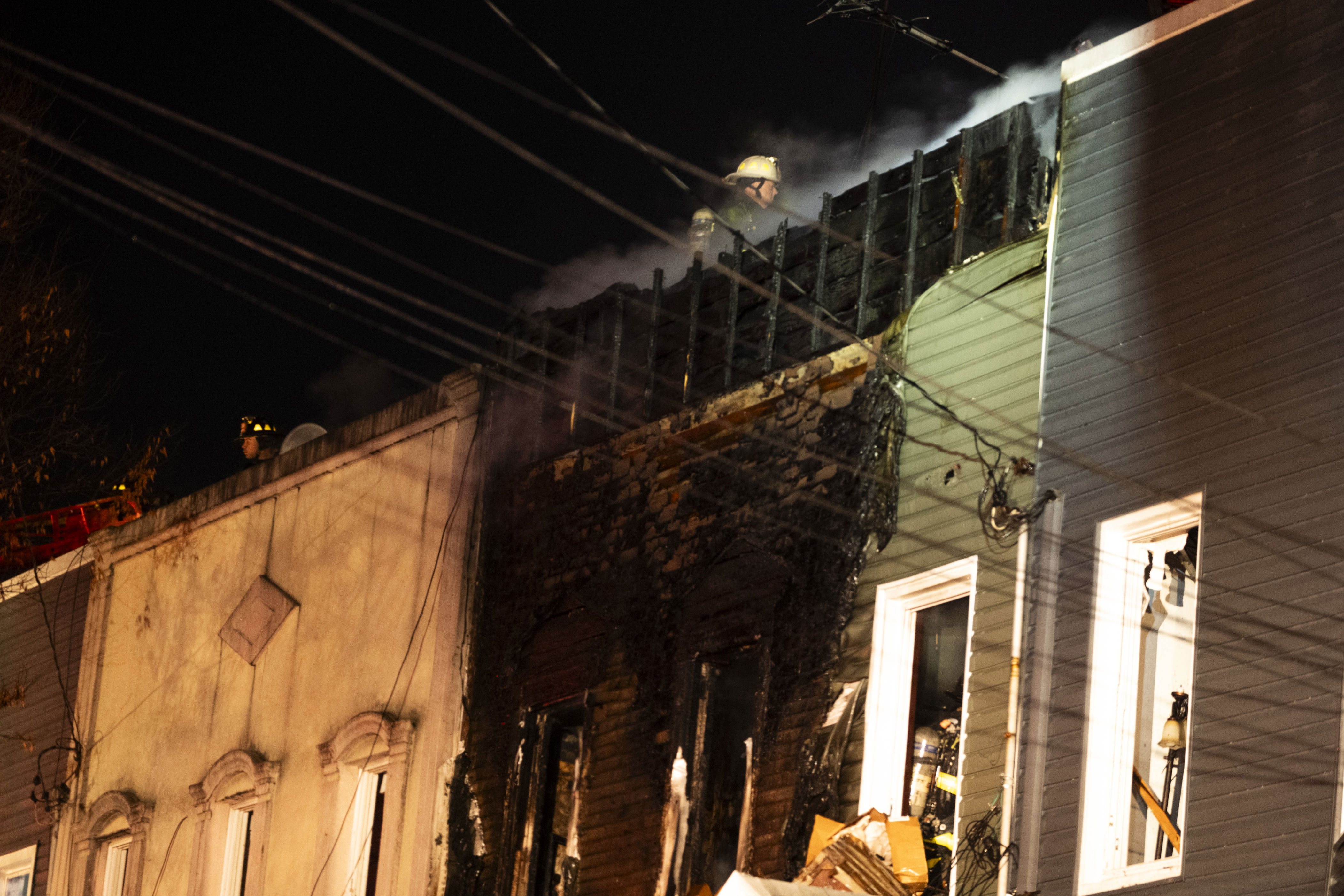 Nearly 20 residents displaced as five-alarm fire tears through four ...