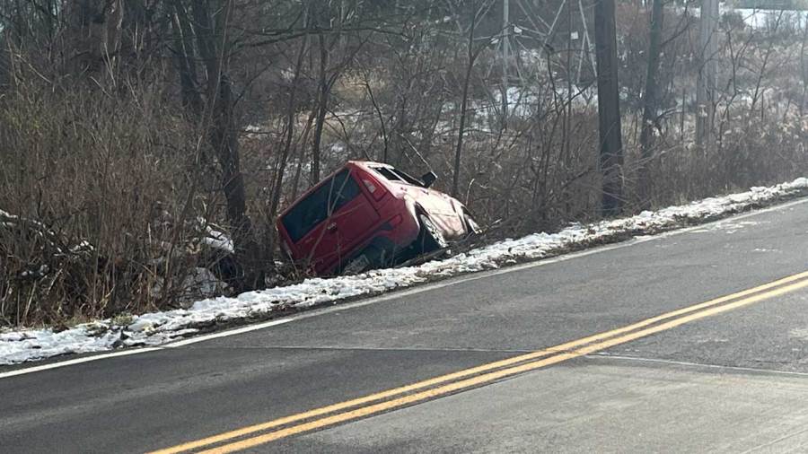 Car ends up between tree and pole in Lowellville