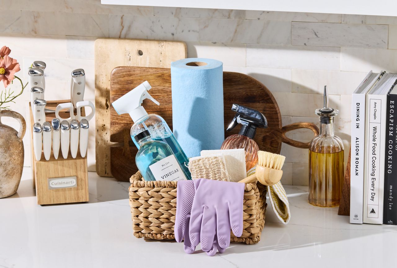 Basket of cleaning supplies on kitchen countertop