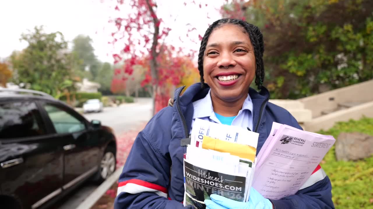 Smiling Saratoga postal carrier delivers mail and holiday cheer