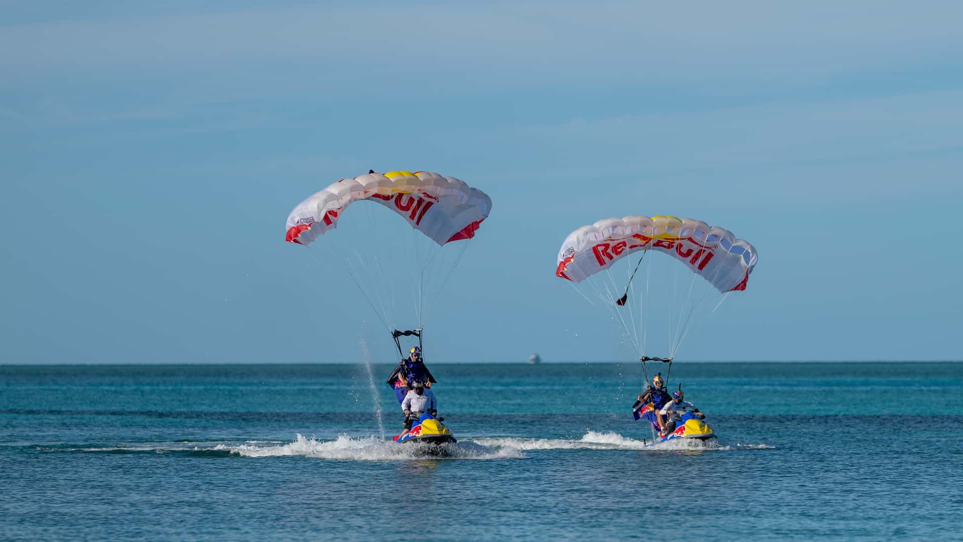 Watch a bunch of PWCs get flung out of a plane and parachute into the water