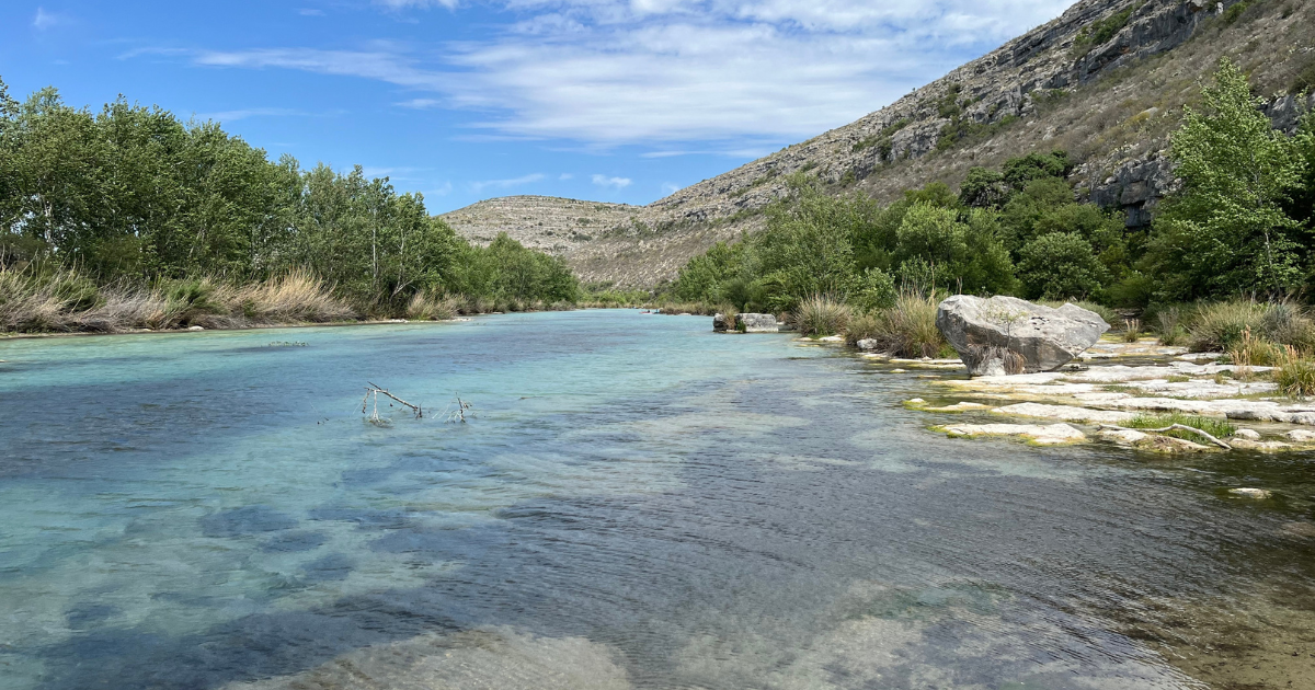 Crystal-clear turquoise water flowing through the rocky landscape of Devils River State Natural Area.
