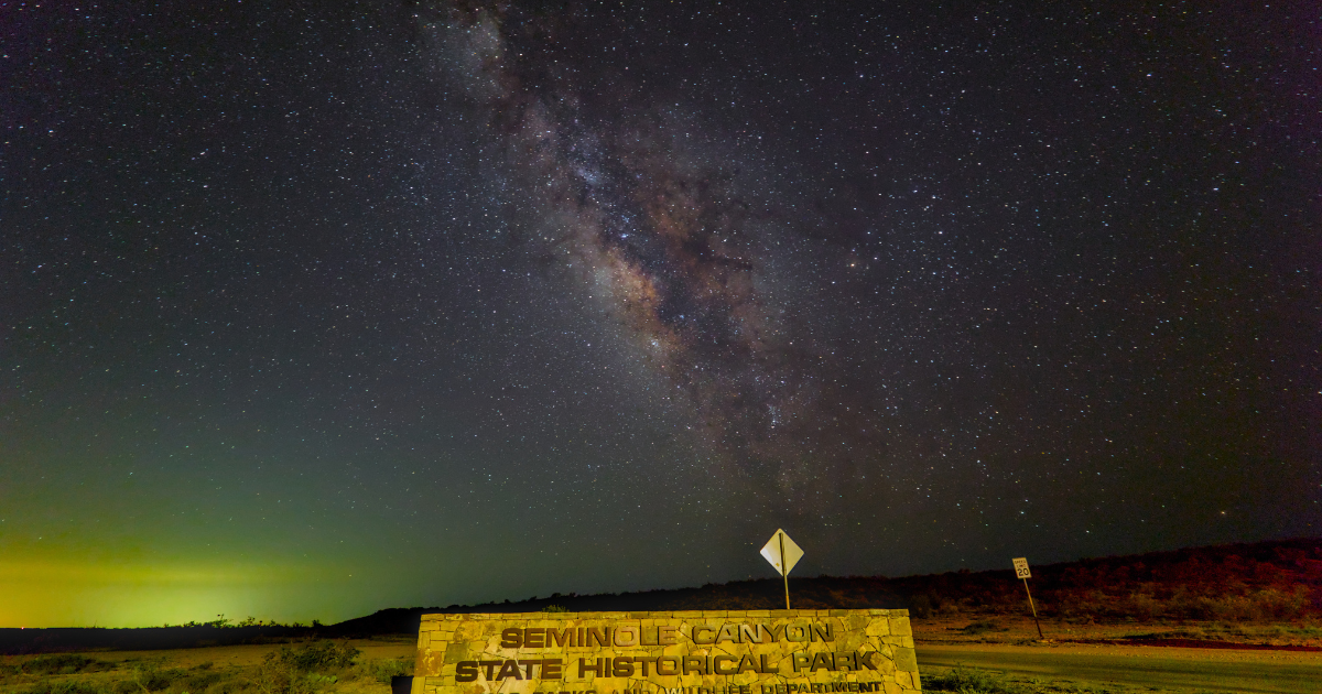 Brilliant Milky Way galaxy shining over the entrance sign at Seminole Canyon State Park.