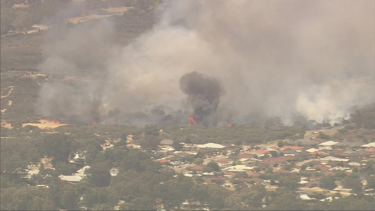 Warnings lowered to watch and act for two Perth bushfires
