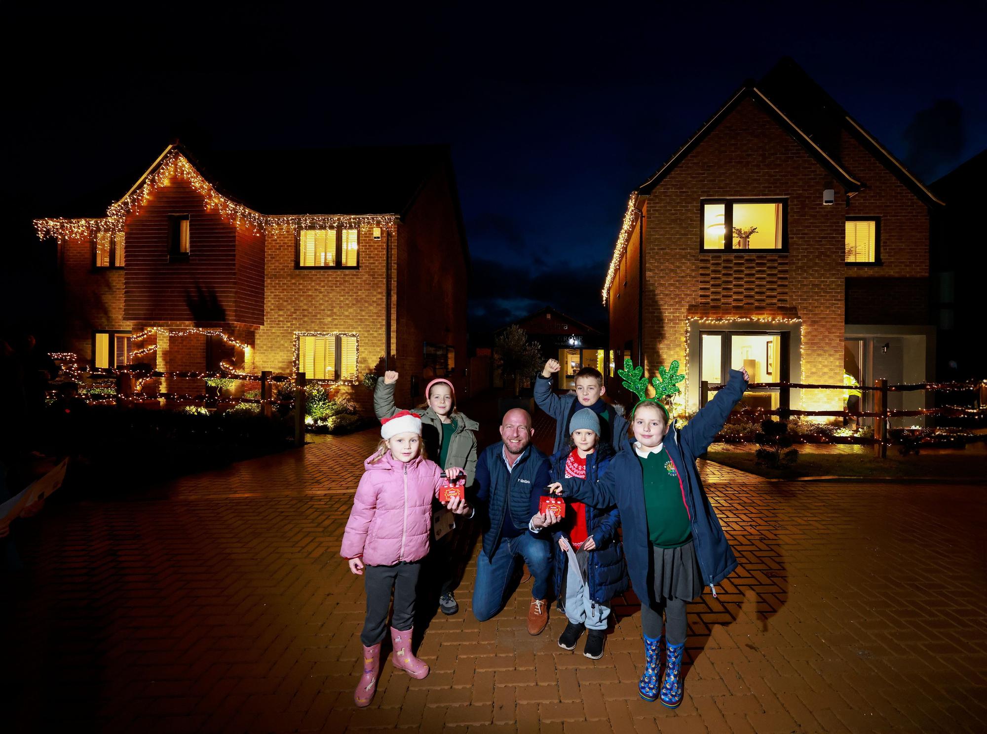 Image showcasing Christmas spirit shines bright at new housing development with lights ...