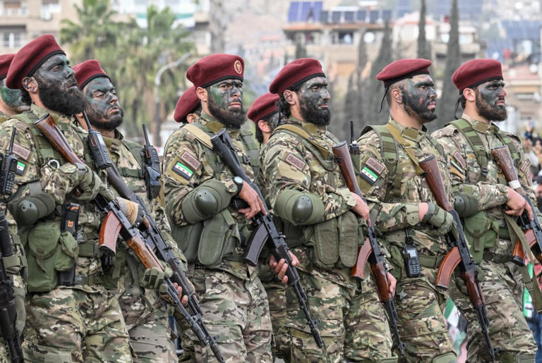 Syrian government forces march at a parade celebrating a year since the fall of President Bashar al-Assad, in Damascus, on December 8.
