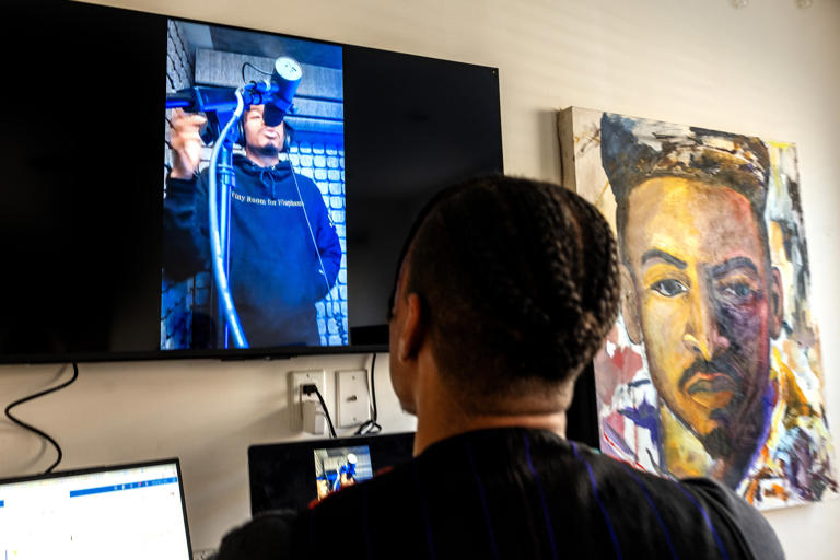 Philly artist Amir Richardson at his home studio Monday, Dec. 1, 2025. He is seen doing the voice-over for new Joel Embiid Skechers Basketball sneakers commercial video.
