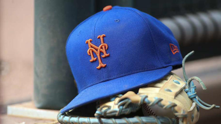 Jul 13, 2022; Atlanta, Georgia, USA; A detailed view of a New York Mets hat and glove in the dugout against the Atlanta Braves in the eighth inning at Truist Park. Mandatory Credit: Brett Davis-Imagn Images | Brett Davis-Imagn Images