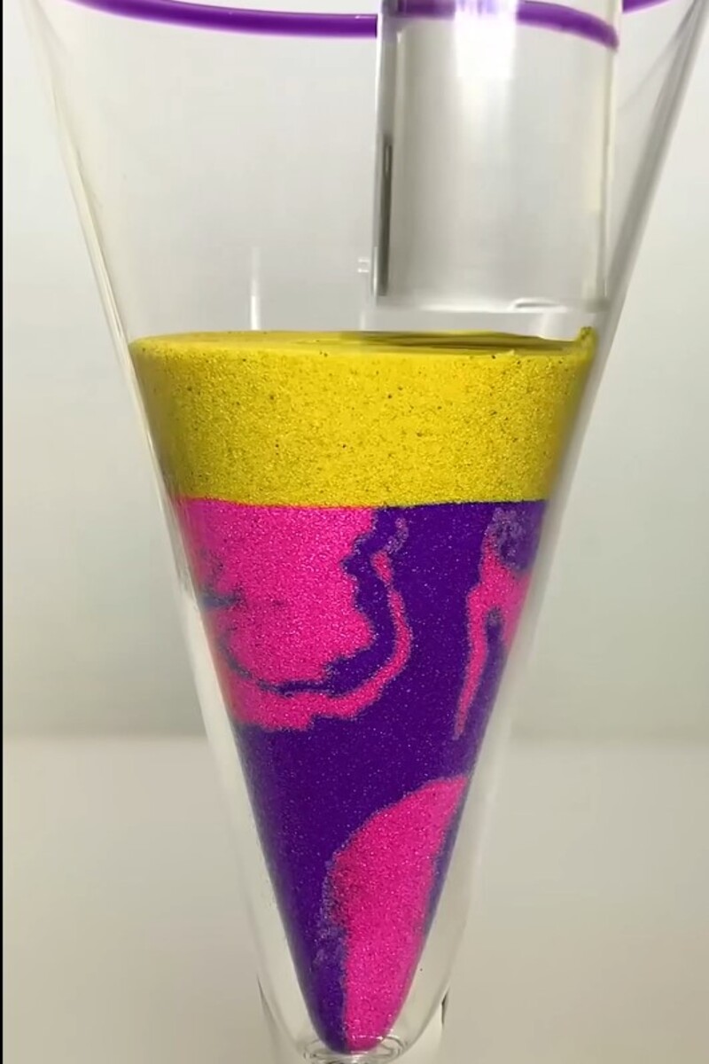 Colorful layered sand art in glass