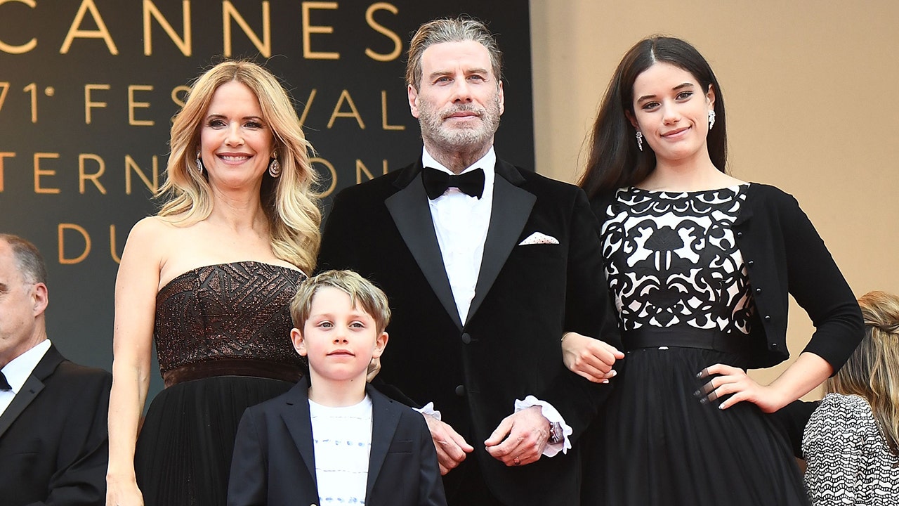 John Travolta (C), his wife US actress Kelly Preston (L) and their children Ella Bleu Travolta (R) and Benjamin Travolta. Getty Images