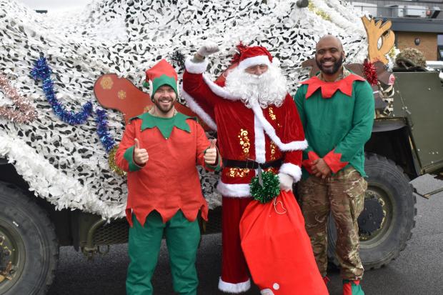 Santa arrives in army vehicle to help spread Christmas spirit