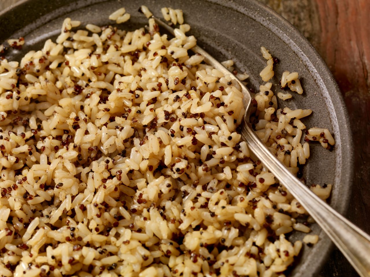 Cooked rice with quinoa in a bowl with a spoon