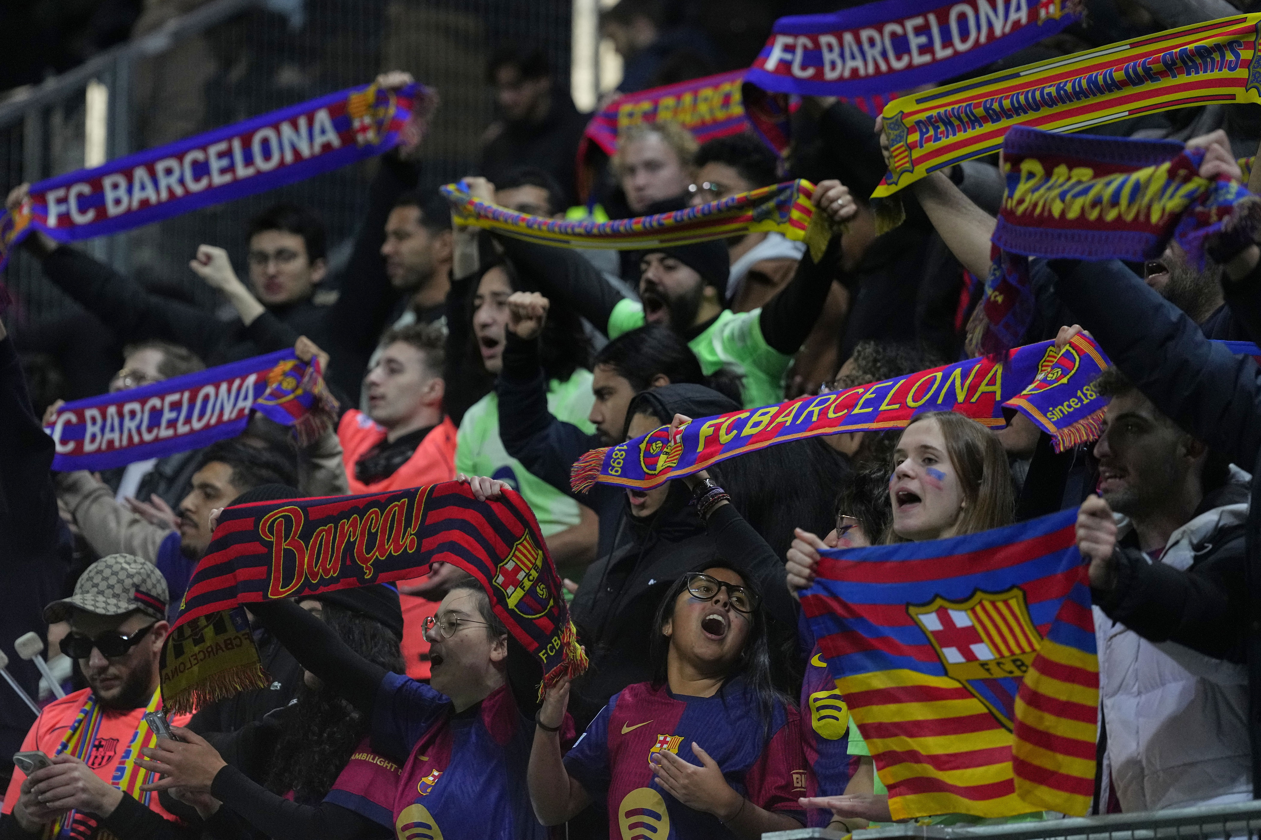 Barcelona fans celebrate after a Women's Champions League soccer match between Paris FC and Barcelona in Paris, Wednesday, Dec. 17, 2025. (AP Photo/Thibault Camus)