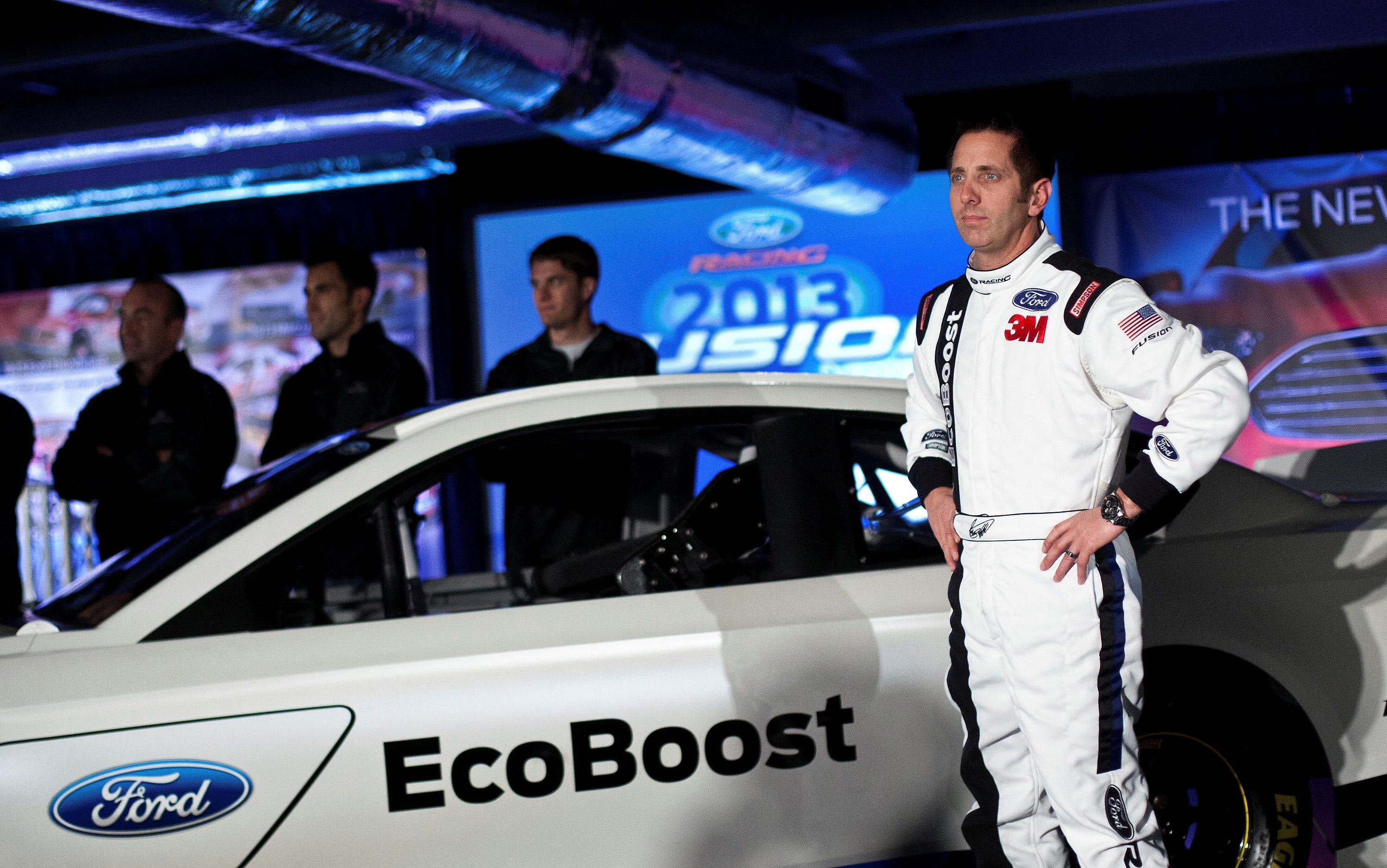 Driver Greg Biffle poses for photographs in front of the new 2013 Ford stock car after an announcement during the NASCAR Media Tour in Concord, North Carolina, January 24, 2012.