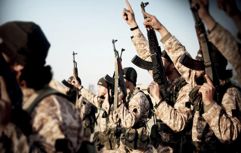 Masked ISIS militants in Raqqa, northern Syria in 2015. (Dabiq / Alamy Stock Photo)