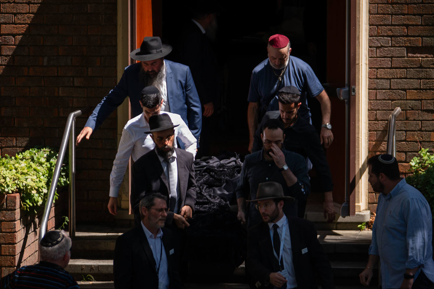 Mourners help carry the coffins of Bondi Beach victims Boris and Sofia Gurman in Sydney on Friday. (Audrey Richardson / Getty Images)