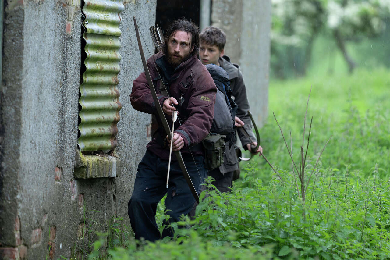 Aaron Taylor-Johnson, left, and Alfie Williams in a scene from "28 Years Later." (Miya Mizuno/Associated Press)