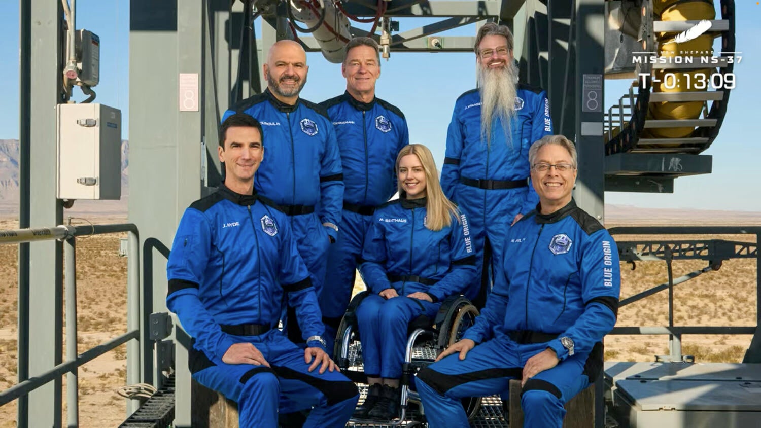 The Blue Origin NS-37 passengers, posing for a photo on the launch pad gantry. Left to right: Joey Hyde, Adonis Pouroulis, Hans Koenigsmann, Michaela Benthaus, Jason Stansell and Neal Milch. / Credit: Blue Origin