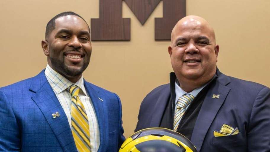 Sherrone Moore, head coach of the University of Michigan, stands next to Warde Manuel, Michigan's director of athletics, during a press conference inside the Junge Family Champions Center in Ann Arbor on Saturday, Jan. 27, 2024. | David Rodriguez Munoz / USA TODAY NETWORK / USA TODAY NETWORK via Imagn Images