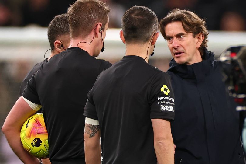 Thomas Frank speaks to referee John Brooks after the Tottenham vs Liverpool game