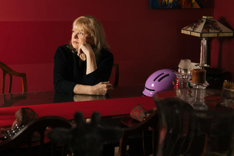 Sylvia Baird's doctors instructed her to stop riding horses. She now wears a purple helmet while she rides an adult tricycle around the neighborhood.