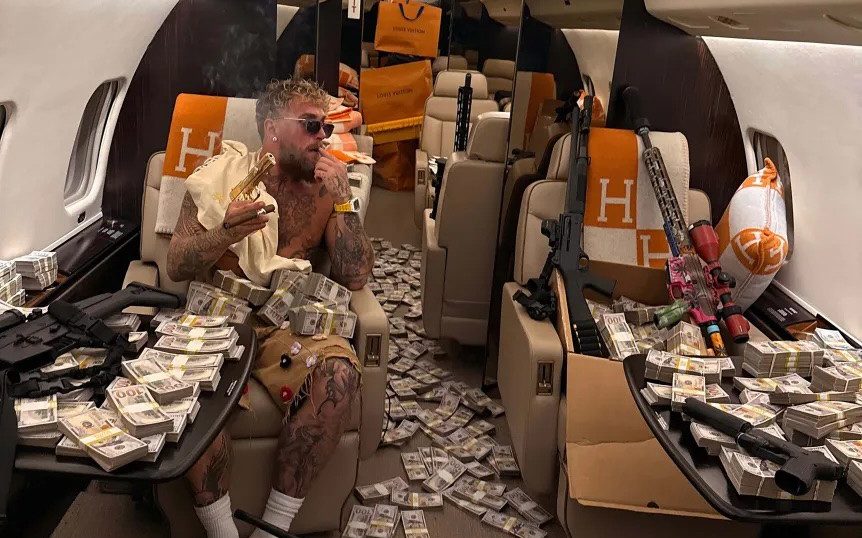 Jake Paul brandishes golden gun and piles of cash after £140m Anthony Joshua fight<br><br>