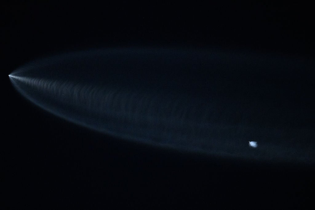 A SpaceX Falcon 9 rocket with Starlink satellites is seen above Lawndale, California after being launched from Vandenberg Space Force Base on 18 June, 2024 (AFP via Getty Images)