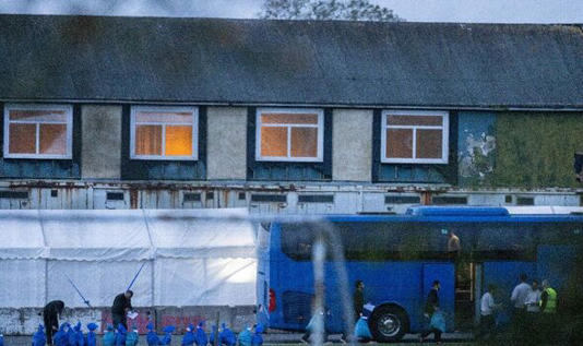 Migrants boarding a bus 