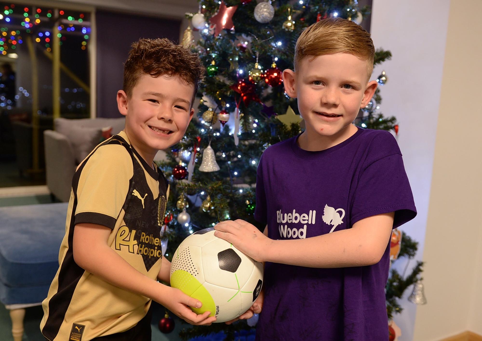 Footballers and young fundraiser bring festive cheer to children's hospice