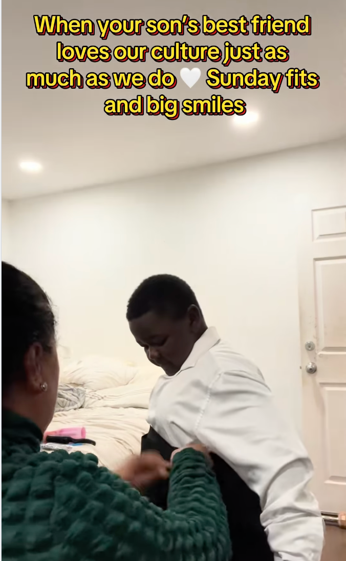 Person helping a boy put on a formal outfit. Overlay text: Son's friend appreciates our culture; Sunday fashion and smiles