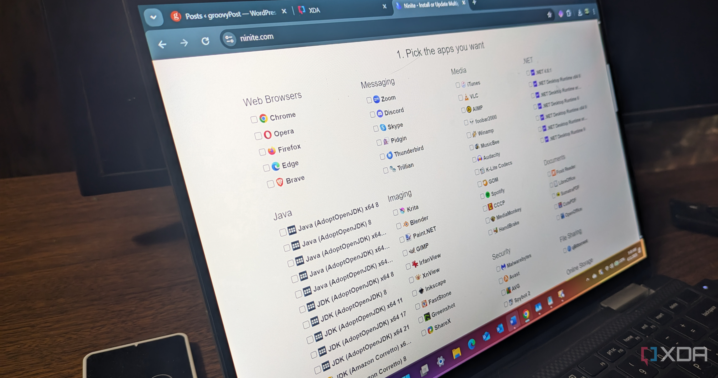 Ninite website showing multiple apps running on a laptop