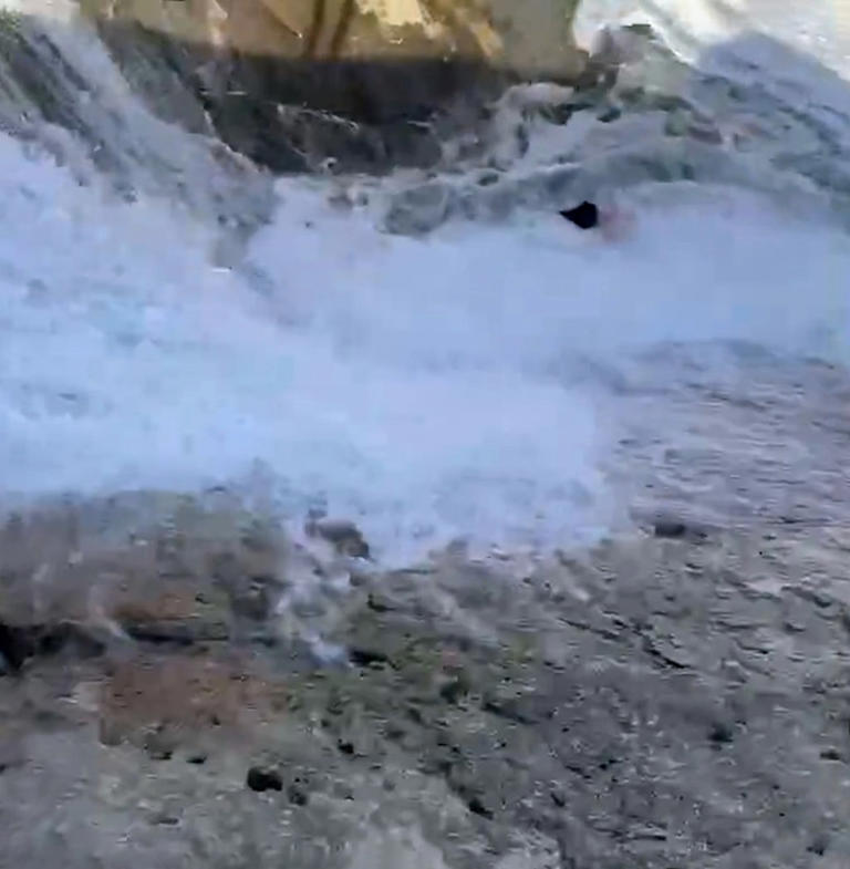 Glamorous tourist almost killed after giant wave smashes her into rocks ...